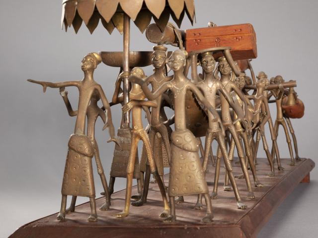 Brass figures on a wooden base